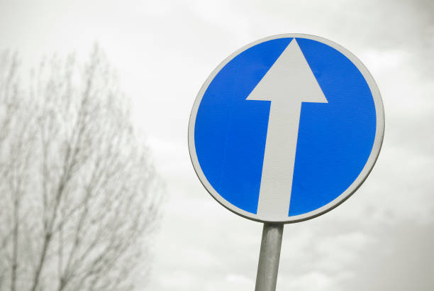 istock Traffic sign with a white arrow. Road sign view. 1301540088