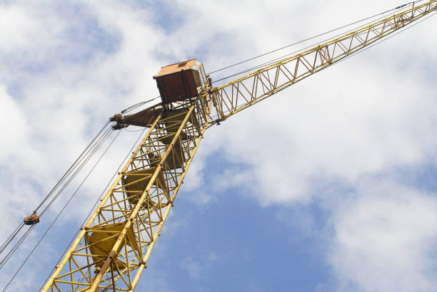 istock Yellow lifting crane. Lifting machine view against the blue sky. 1301540136