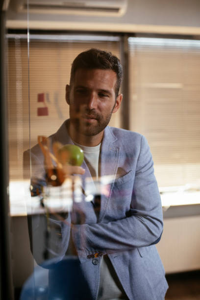 istock Handsome businessman making a business plan. 1301543070