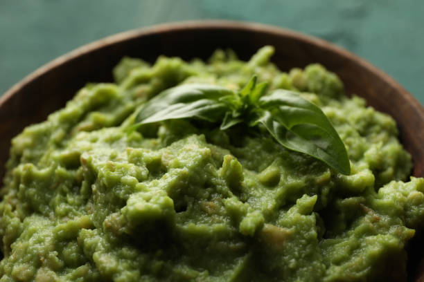 istock Bowl with guacamole and basil, close up 1301545888