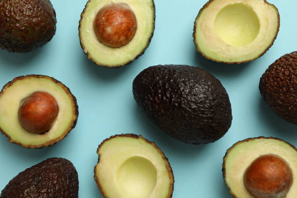 istock Ripe avocado on blue background, top view 1301545910