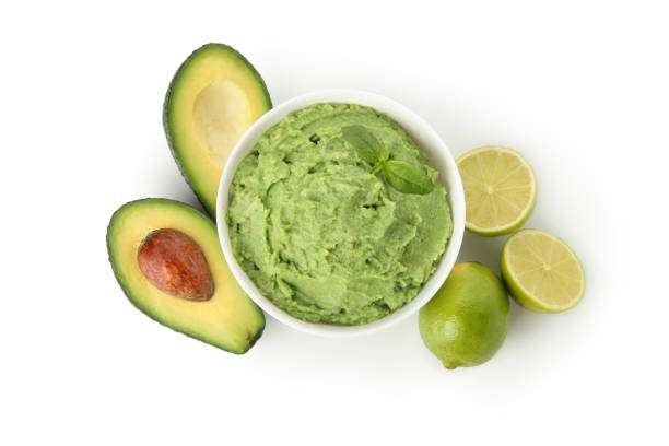istock Bowl of guacamole, avocado and lime isolated on white background 1301546547