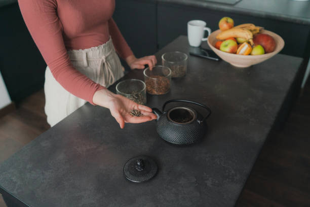 istock Woman brewing loose leaf tea 1301546933