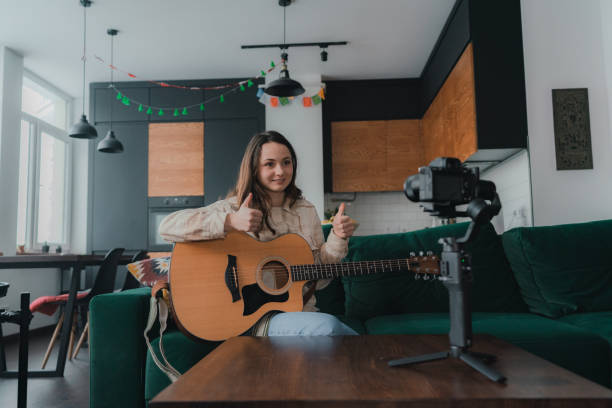 istock Woman making video of her playing guitar 1301547072