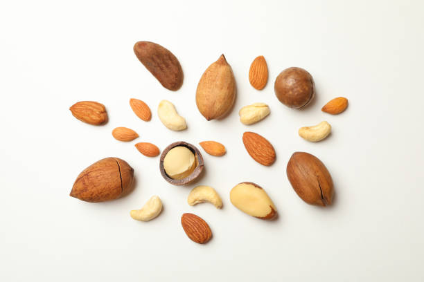 istock Different types of tasty nuts on white background 1301547167