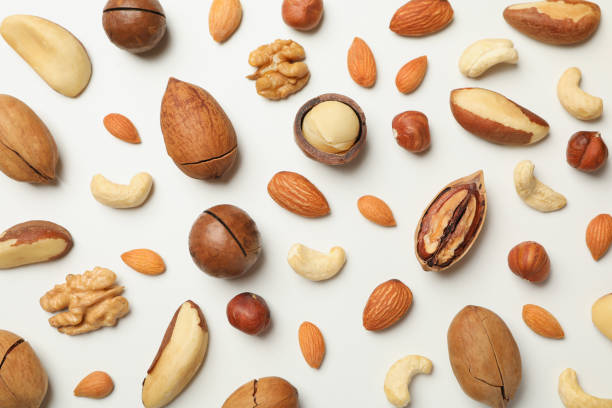 istock Different tasty nuts on whole background, close up 1301547590
