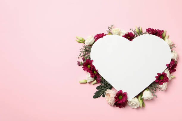 istock Blank heart and different flowers on pink background, space for text 1301548466