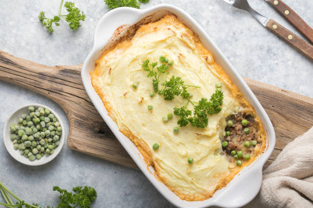 istock Shepherd's Pie with ground beef, potato and cheese on wooden background, top view, copy space. Traditional homemade Irish casserole 1301548717