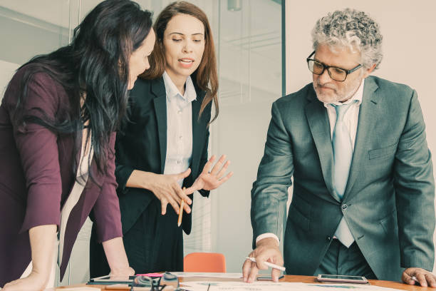 istock Confident businesspeople discussing project together 1301548810