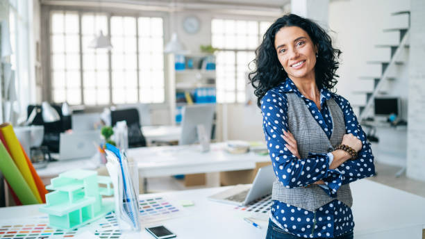 istock Mid adult woman working on new architectural project 1301550840