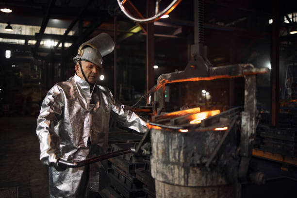 istock Foundry worker ready to pour liquid iron into molds. Casting and steel production. 1301550850