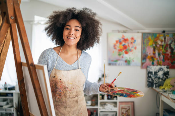 istock Afro Female fine artists drawing in studio 1301550853