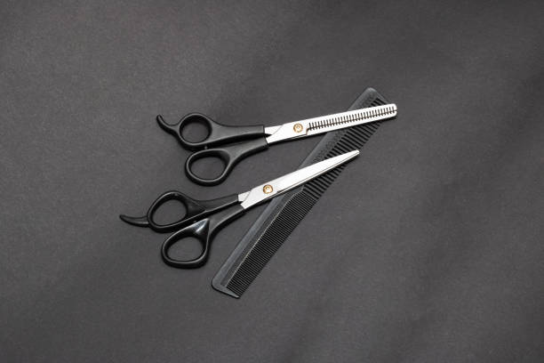 istock Hairdressing scissors and comb on gray background 1301552326