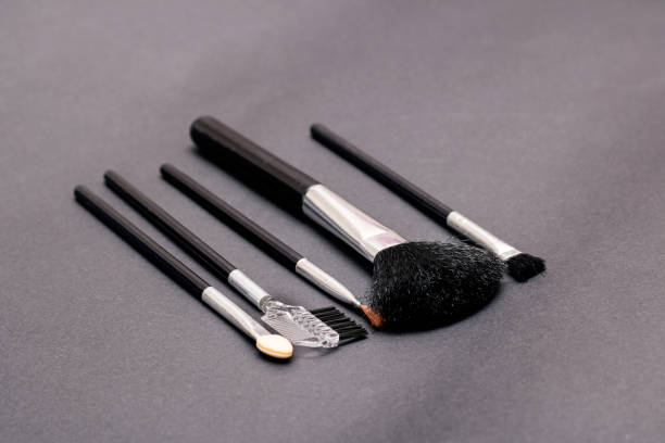 istock Makeup brushes on a purple background closeup 1301552339