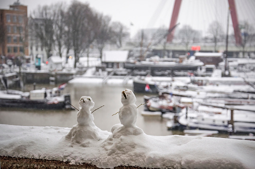 Two tiny snowmen built after the first serious snowfall in years near the Old Harbour in Rotterdam, The Netherlands