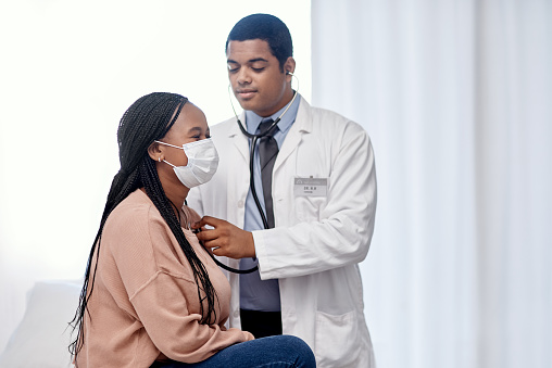 Shot of a doctor examining a patient with a stethoscope