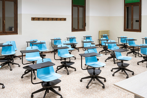 A classroom in a university. Rows of desks and chairs