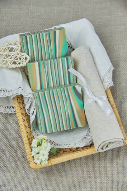 istock Fragrant striped handmade soap in a wicker basket on a white napkin. 1301556172