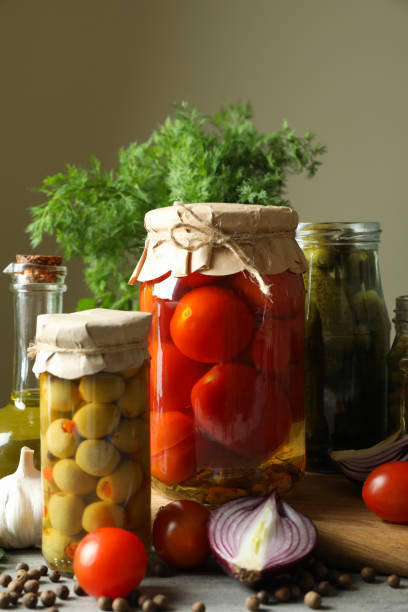 Different pickled food and ingredients on gray wooden table