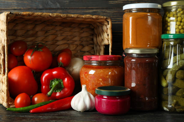 istock Jars with different canned food on wooden background 1301556415