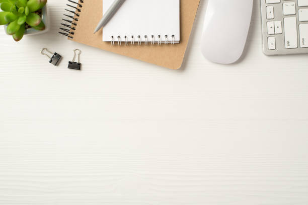 istock Above flatlay view photo of office stationery and computer pc accessories making frame isolated white backdrop 1301556617