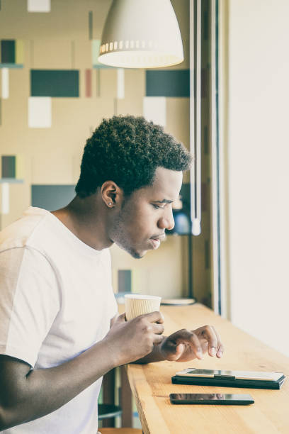 istock Serious young African American man drinking coffee 1301557336