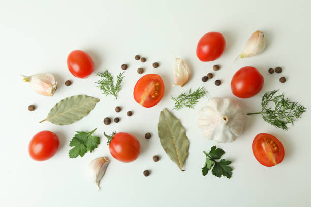 istock Flat lay with tomatoes, dill, pepper, garlic and bay leaves on white background 1301557470