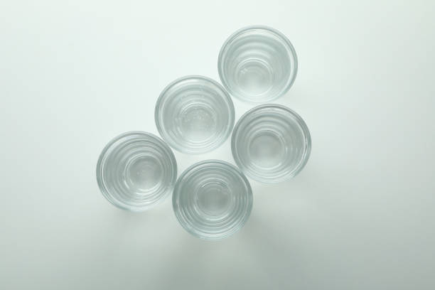 istock Shots of vodka or tequila on white background 1301557532