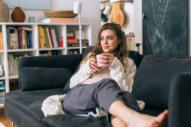 istock woman relaxing at home 1301557711
