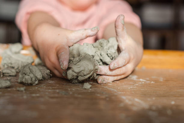Children hands molding clay Unrecognizable child molding clay at home childs play clay stock pictures, royalty-free photos & images