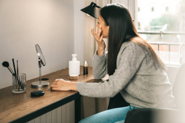 istock Woman trying on cosmetics 1301557945