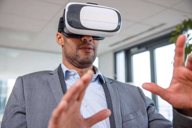 istock Business professional interacting with a virtual headset in his office 1301559070