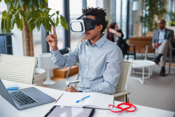 istock Business professional interacting with a virtual headset in his office 1301559097
