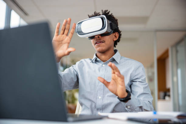 istock Business professional interacting with a virtual headset in his office 1301559142