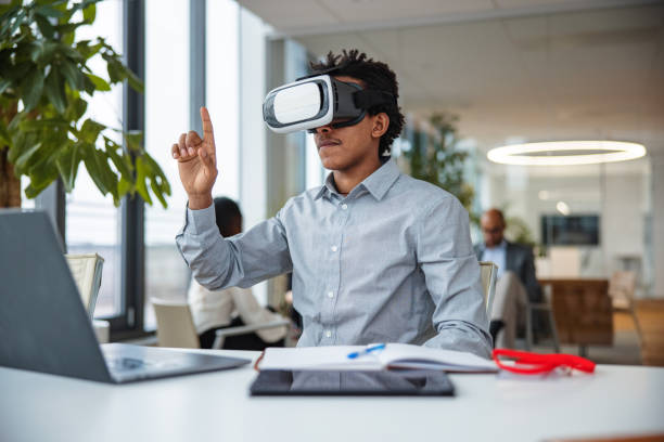 istock Business professional interacting with a virtual headset in his office 1301559184