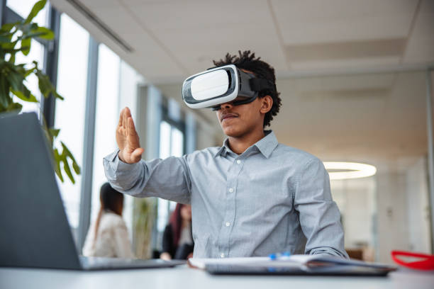 istock Business professional interacting with a virtual headset in his office 1301559228