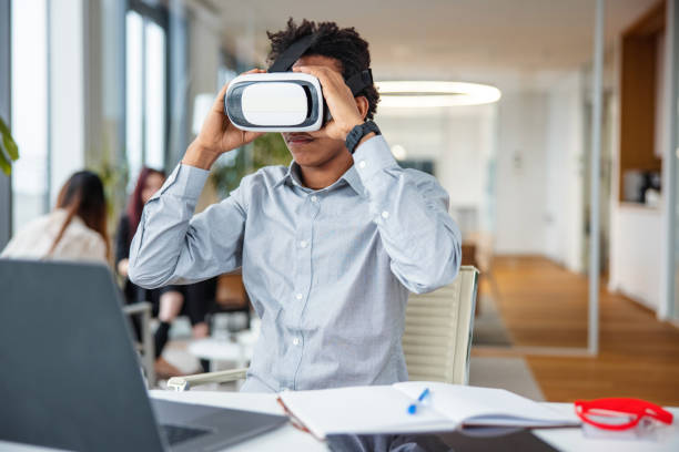 istock Business professional interacting with a virtual headset in his office 1301559378