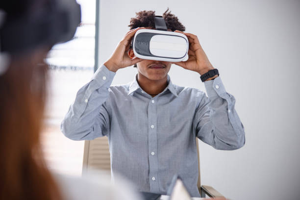 istock Business professional interacting with a virtual headset in his office 1301560074