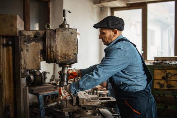 istock Hardworking mature man and young beautiful manual workers 1301560235
