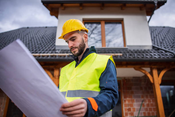 istock Caucasian Construction Worker Holding A Blueprint And Looking Around 1301560509
