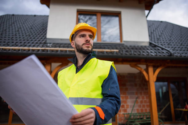 istock Caucasian Construction Worker Holding A Blueprint And Looking Around 1301560543