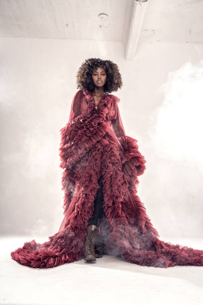 Fashionable young afro woman posing in maxi dress with ruffles, Fashionable young afro woman posing in maxi dress with ruffles, looking at camera. maxi length stock pictures, royalty-free photos & images