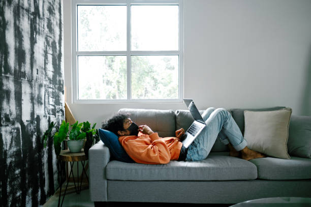 istock Young Adult Man Chilling at Home and Using Laptop 1301561766
