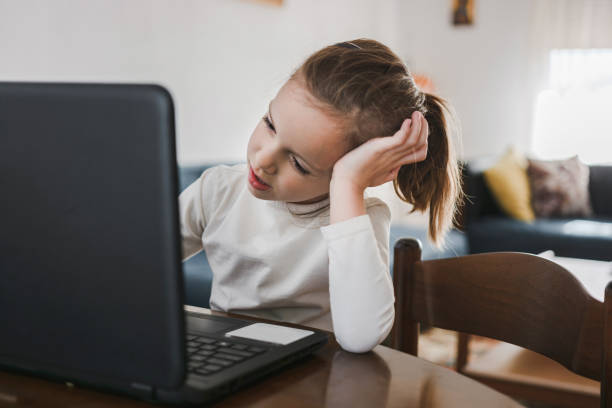 istock Little girl looking at laptop 1301561773