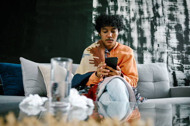 istock Young Adult Man with Blanket Feeling Sick at Home 1301561861