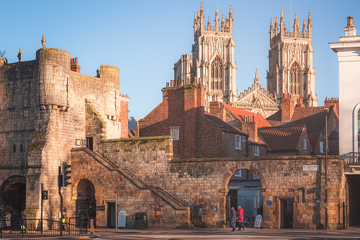 Afternoon golden light on the historic old town of York and ancient city walls at St. Leonard's Place looking towards York Minster Cathedral.