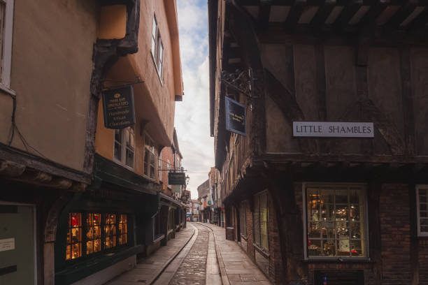 The Shambles, York The Shambles in old town York, featuring traditional medieval timber frame overhang buildings, is a popular tourist attraction and shopping area. york yorkshire stock pictures, royalty-free photos & images