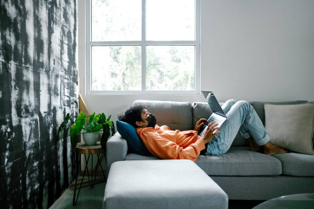 istock Young Adult Man Chilling at Home and Using Laptop 1301562277