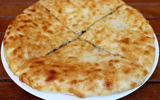 Photo of Plate of Kubdari, the North-western Georgian Traditional Flat Bread Stuffed with Spiced Pork or Beef