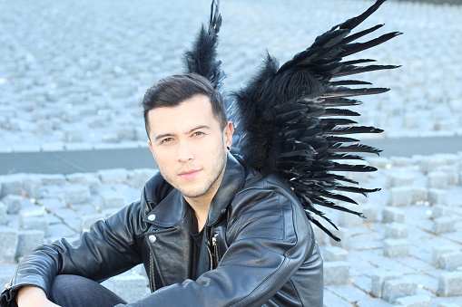 Urban angel with black wings.